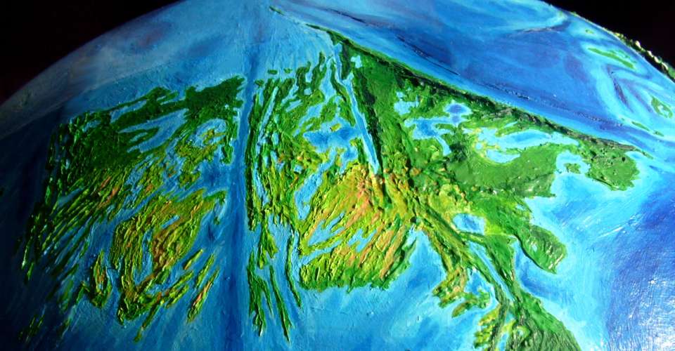 Orbital photo of Whartonia, equivalent of Earth's eastern Indian Ocean off Australia, on Abyssia, an Earth where up is down and down is up. A low, tropical, forested continent with a fractal coast and long twisting lakes.