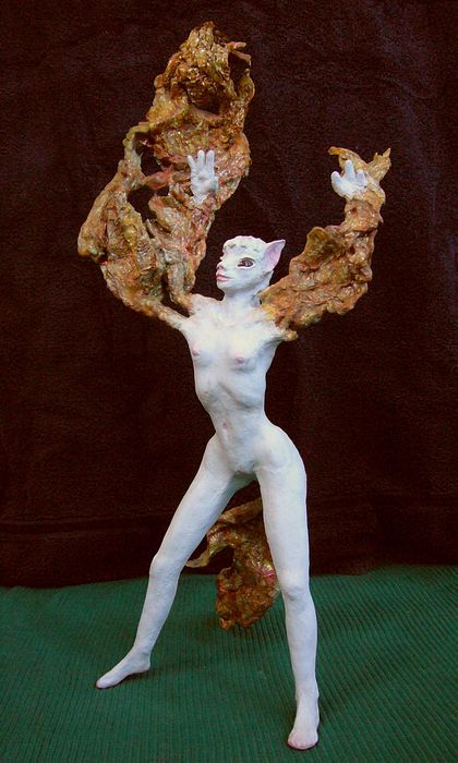 Coyotegirl faces left as her arms stretch into smoky wings. Sculpture by Wayan. Click to enlarge.