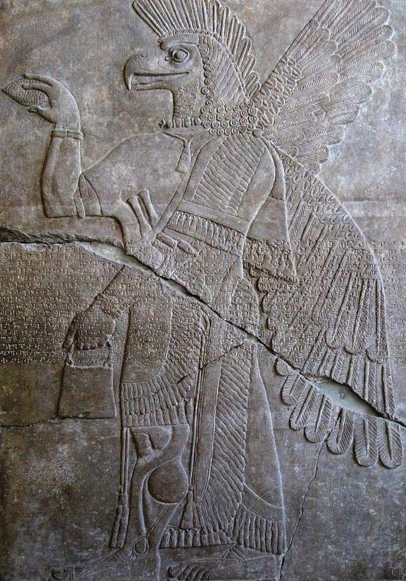 Mesopotamian carving of figure in profile with hawk's head and wings. Berlin Museum.